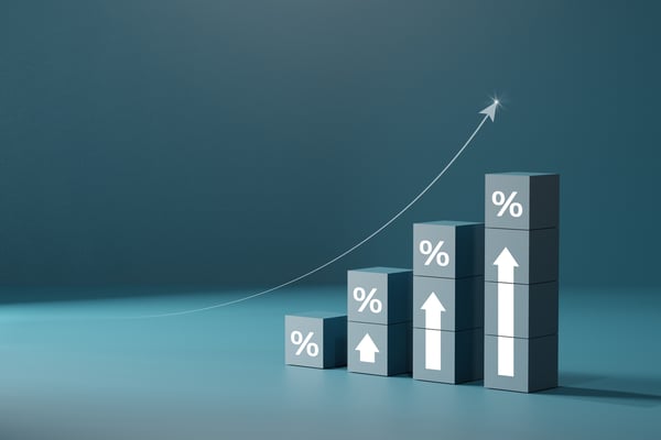Ascending bar chart with percentage symbols and upward arrows showing growth trend against blue background